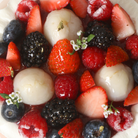 Close-up of fresh berry and lychee cake topping, perfect for special occasion delivery in Singapore.